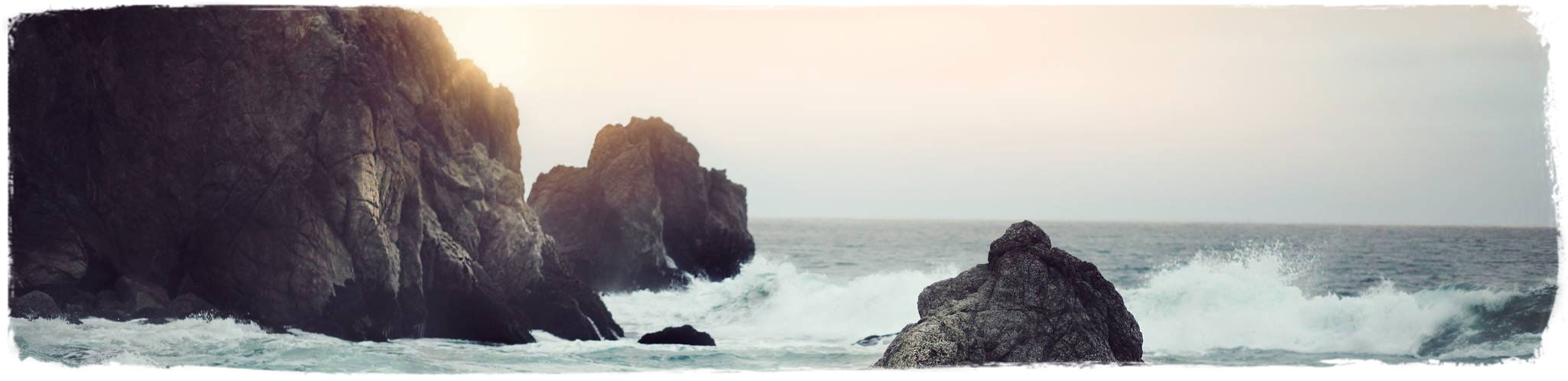 Ocean waves crashing on large rocks